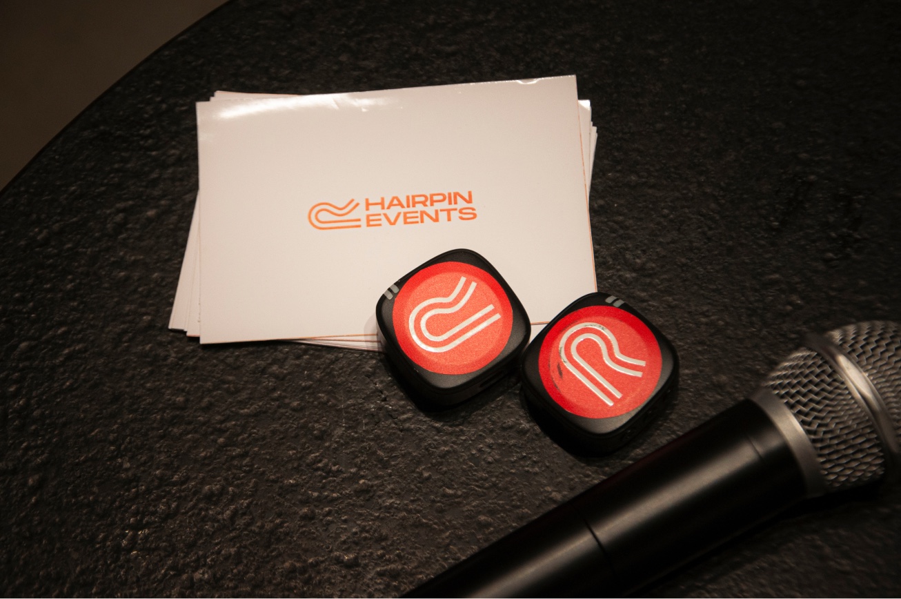 Grid to Grind branded coasters beside a microphone.